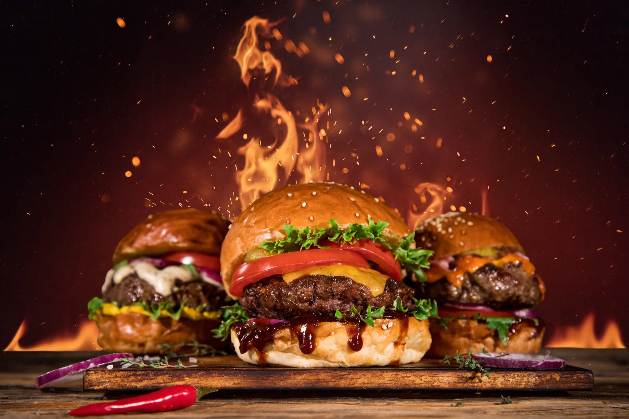 burger-trio-mit-feuer-hintergrund